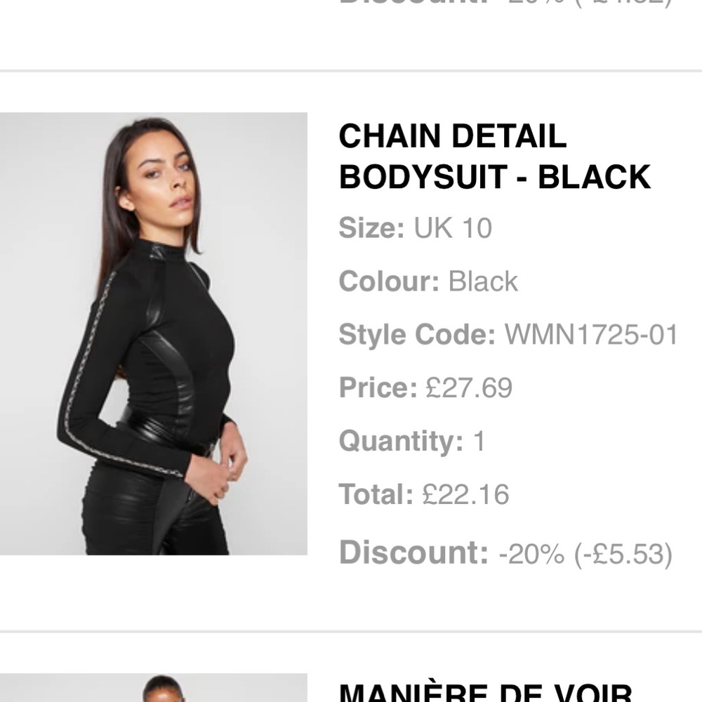 Black body suit with silver chains on the arms
